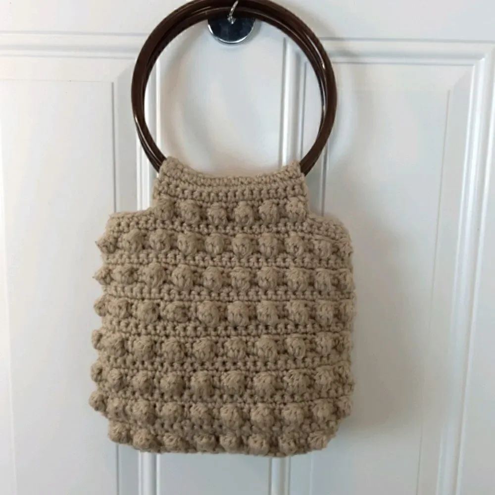 Tan knitted yarn handbag with two ring handles